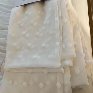 Four 96” x 50” sheer window panels Poppy by DKNY.